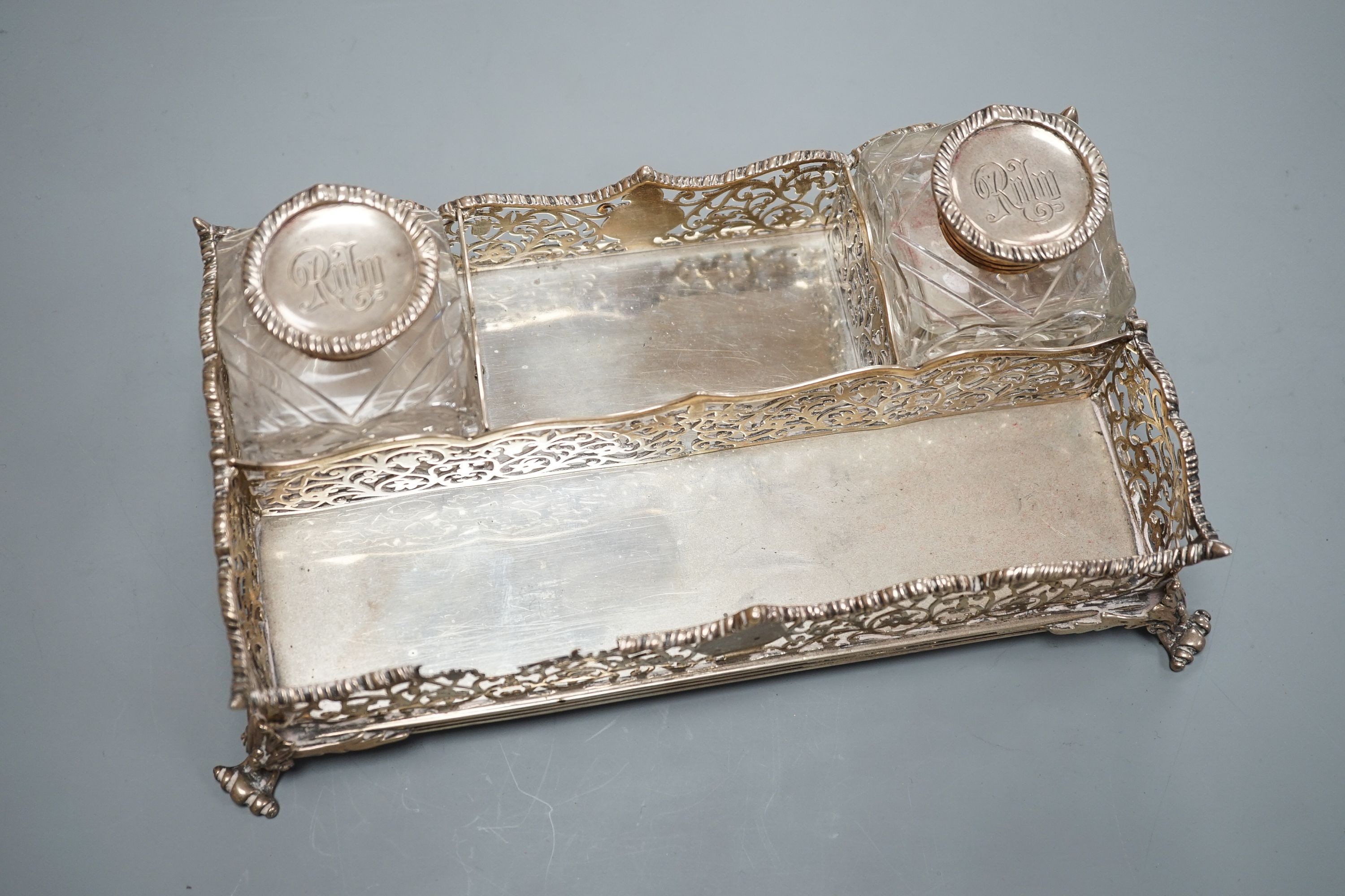 A late Victorian pierced silver twin inkstand, with two mounted glass inkwells, (a.f.), London, 1884, 25.3cm, 18.5oz.